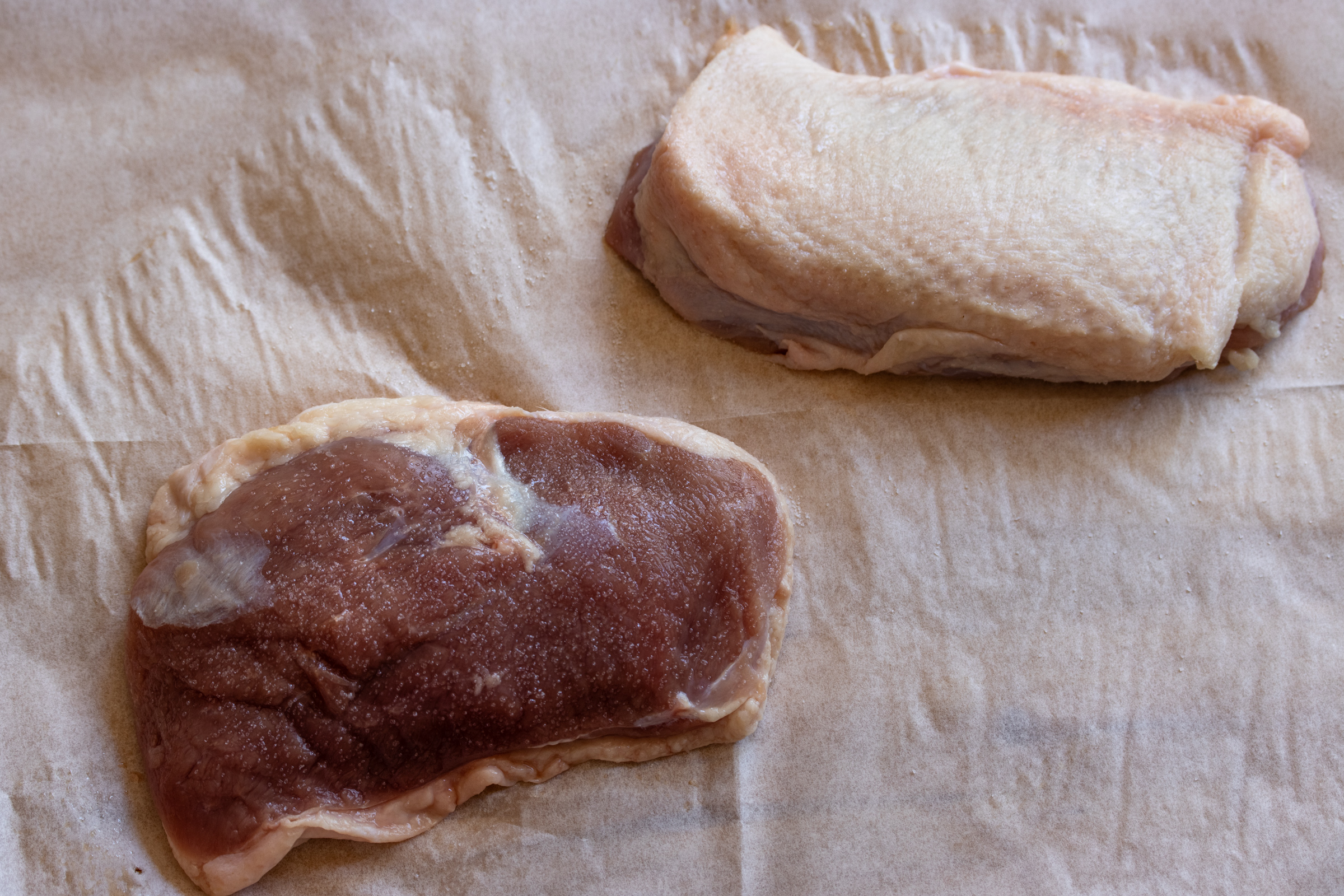 Breasts of duck trimmed and seasoned with salt. 