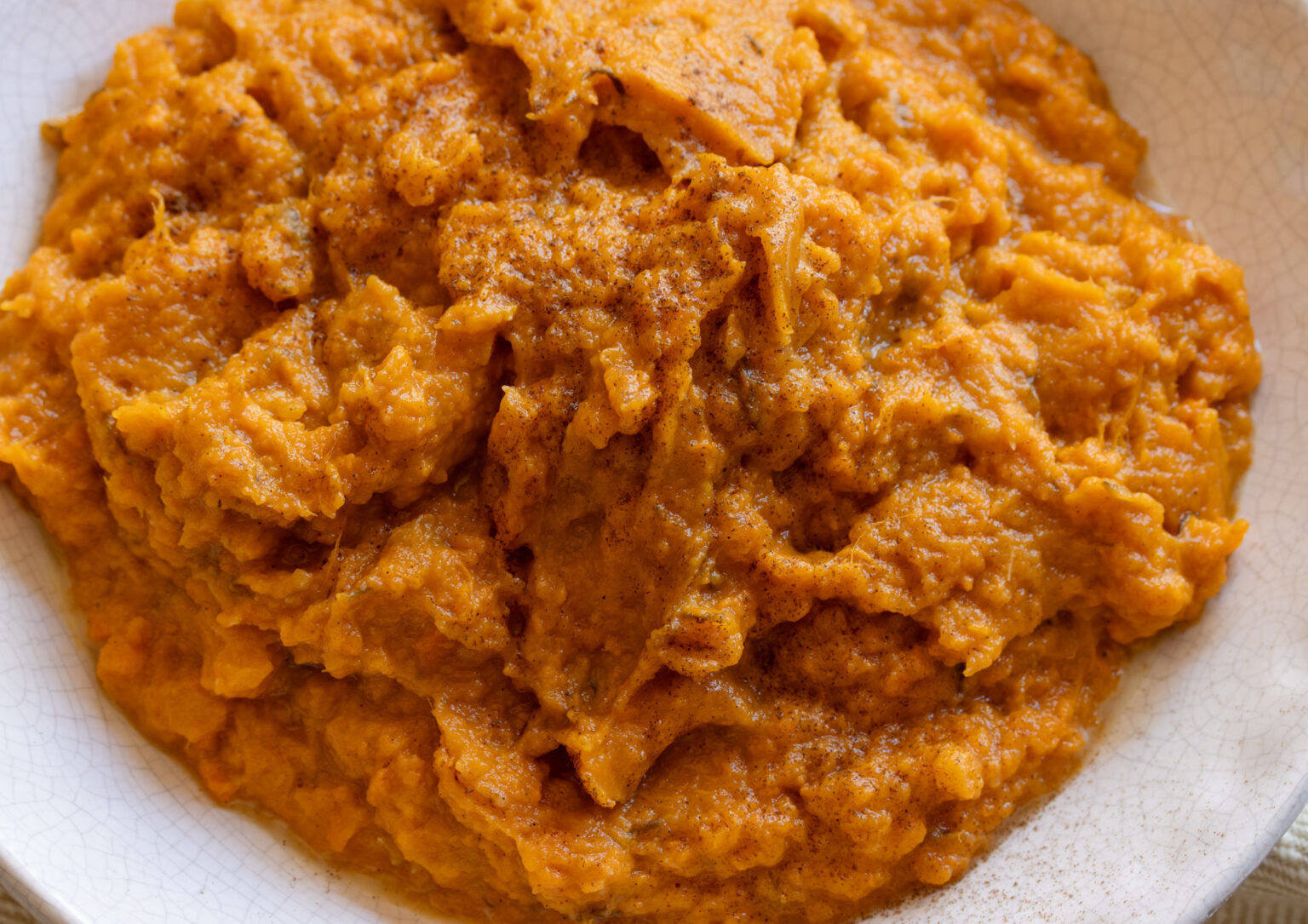Dash of cinnamon sprinkled over the sweet potatoes ready to be served.
