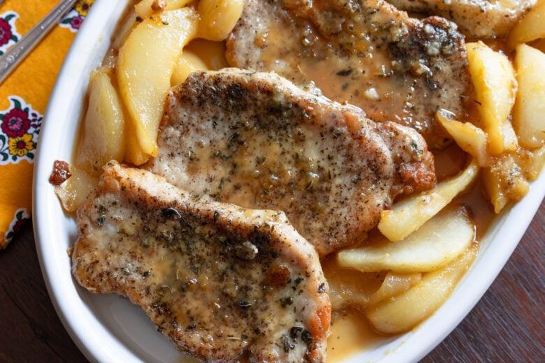 Pork chops served in a white plate.