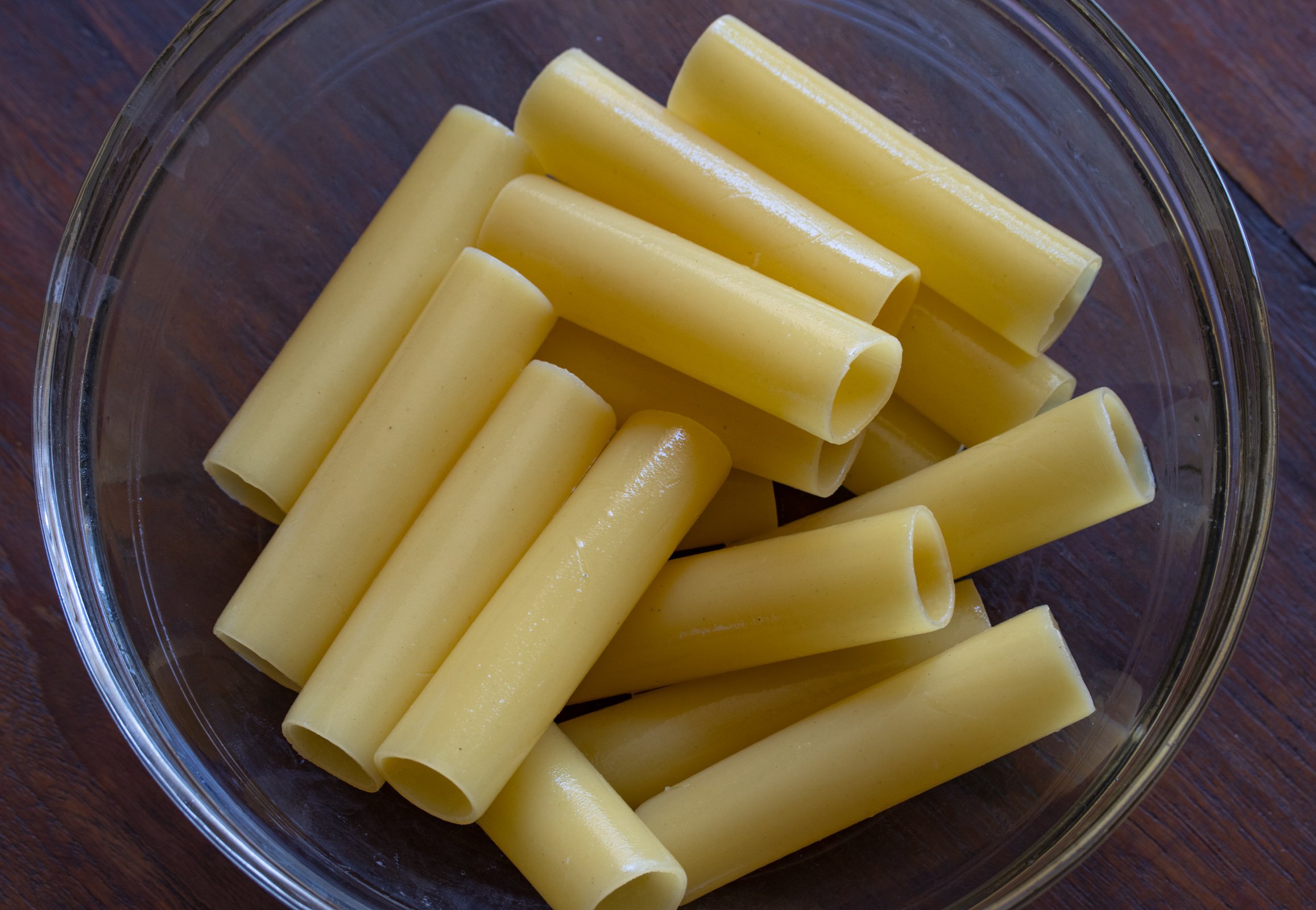 Part cooked cannelloni ready to be filled.