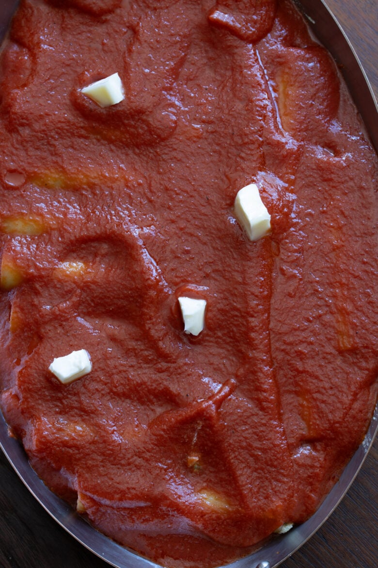 Butter dotted cannelloni ready to go in the oven for baking.