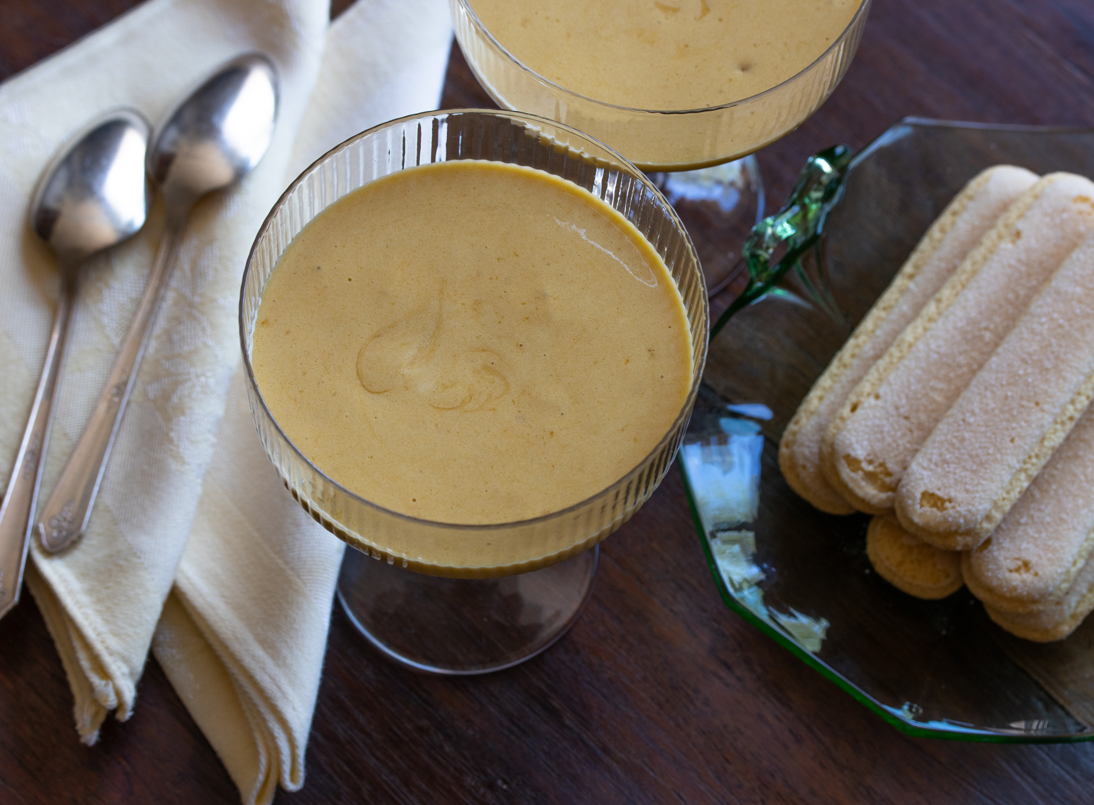 Sabaione done and poured into glasses served alongside lady's fingers.