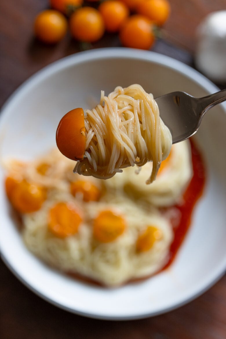 Close up of a forkfull of angel hair pasta ready to be enjoyed.