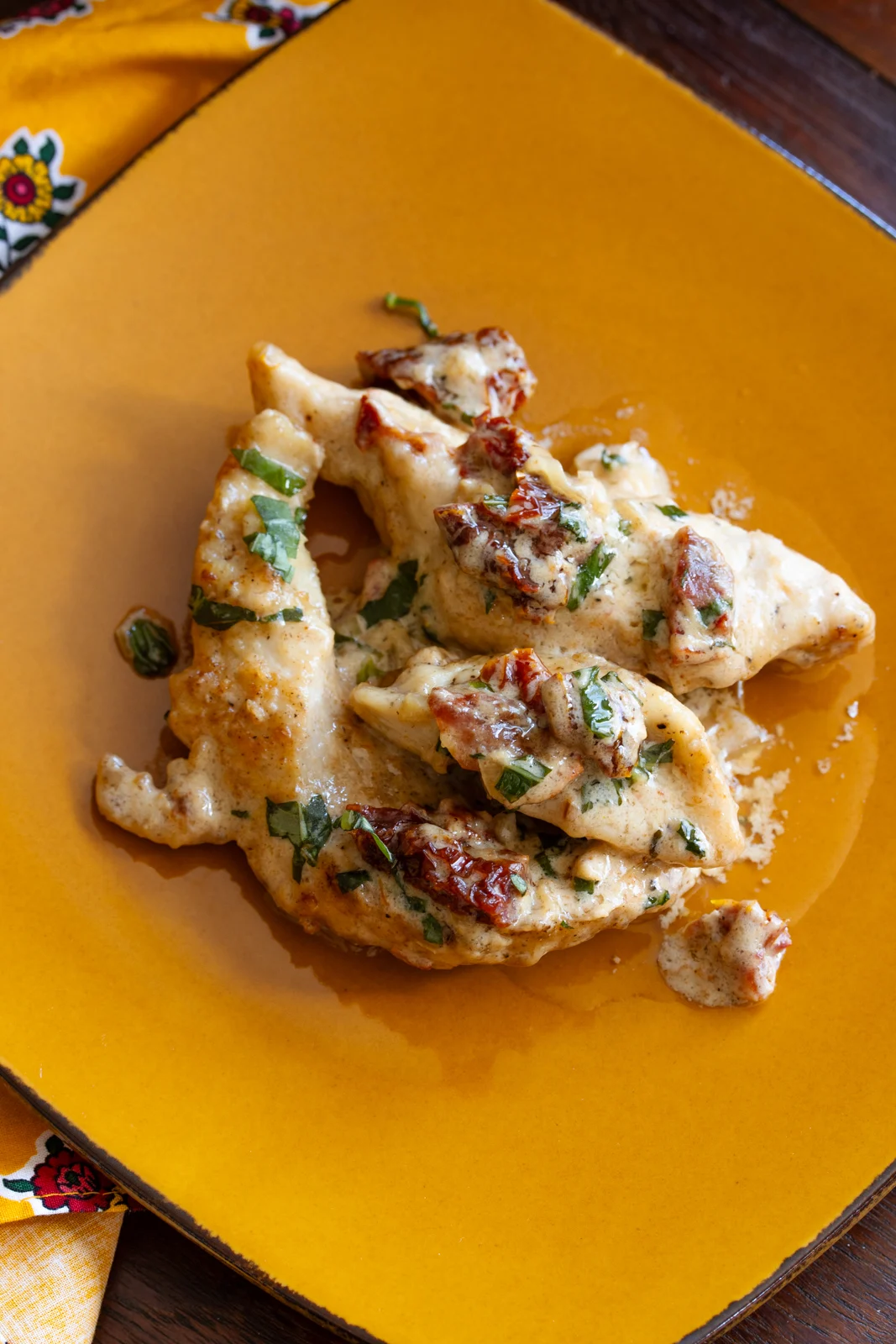 Chicken with sund dried tomato on a plate ready to be enjoyed.