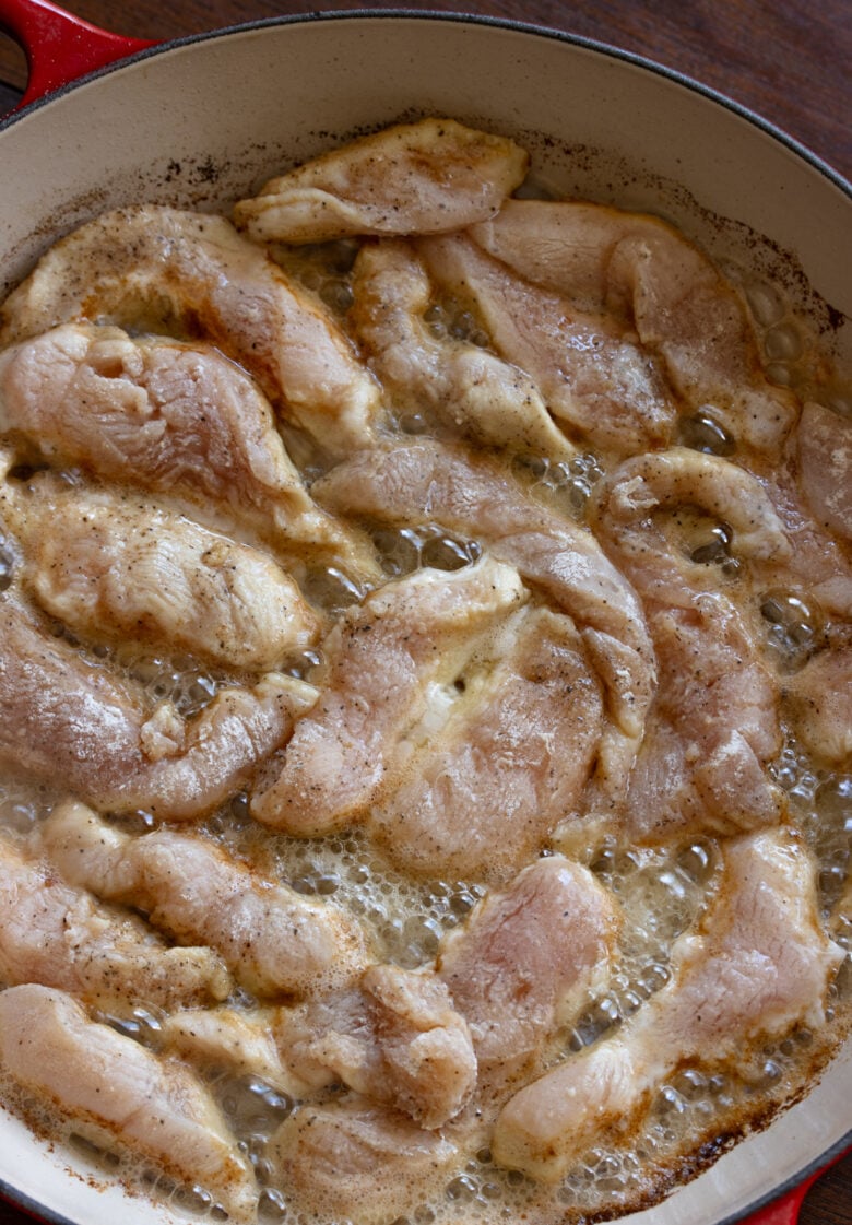 Chicken strips sauted in butter and olive oil in a large skillet. 