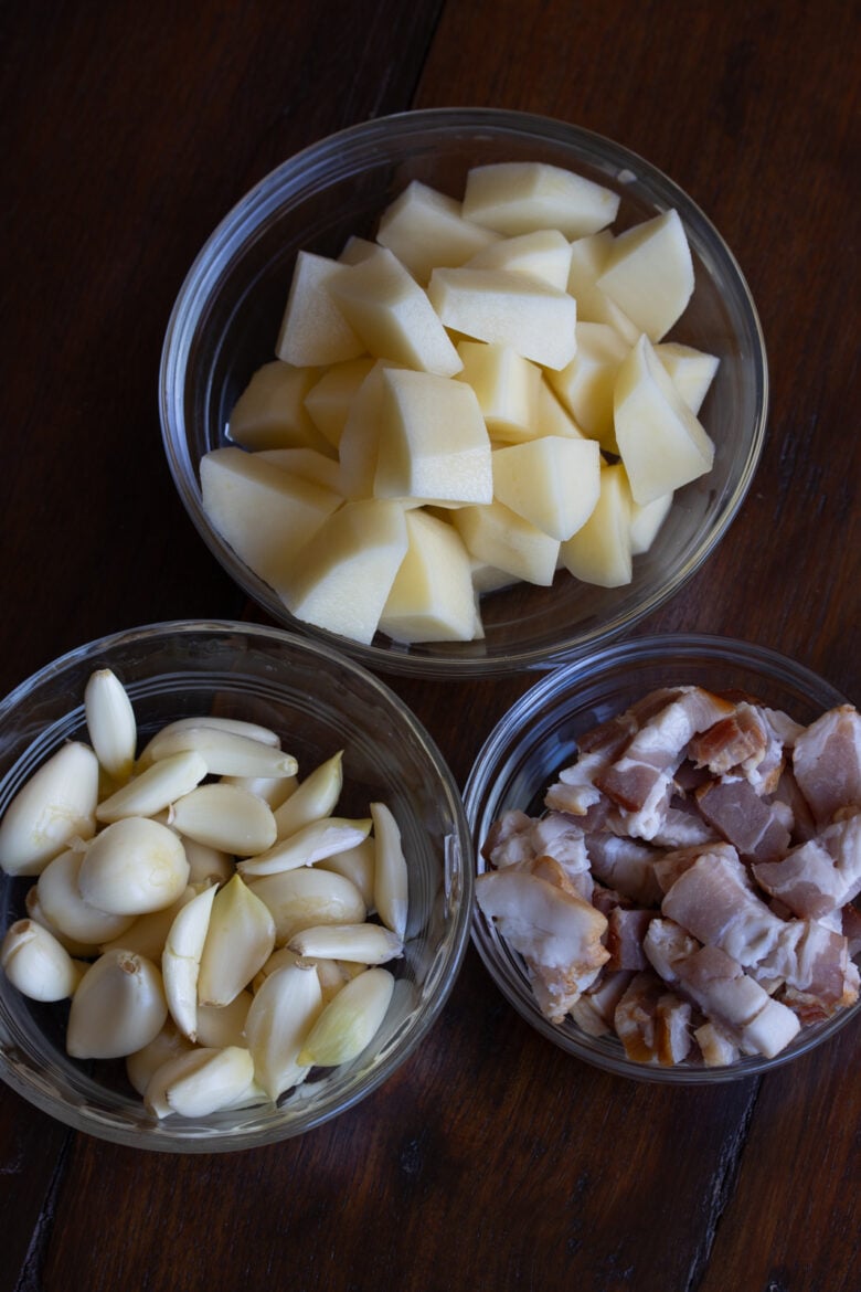 Bacon, potatoes and garlic all prepared for cooking. 