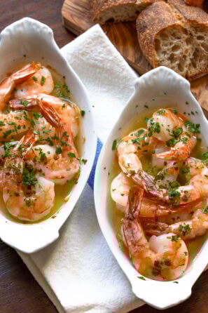 Garlic butter shrimp in a white individula gratin dishes.