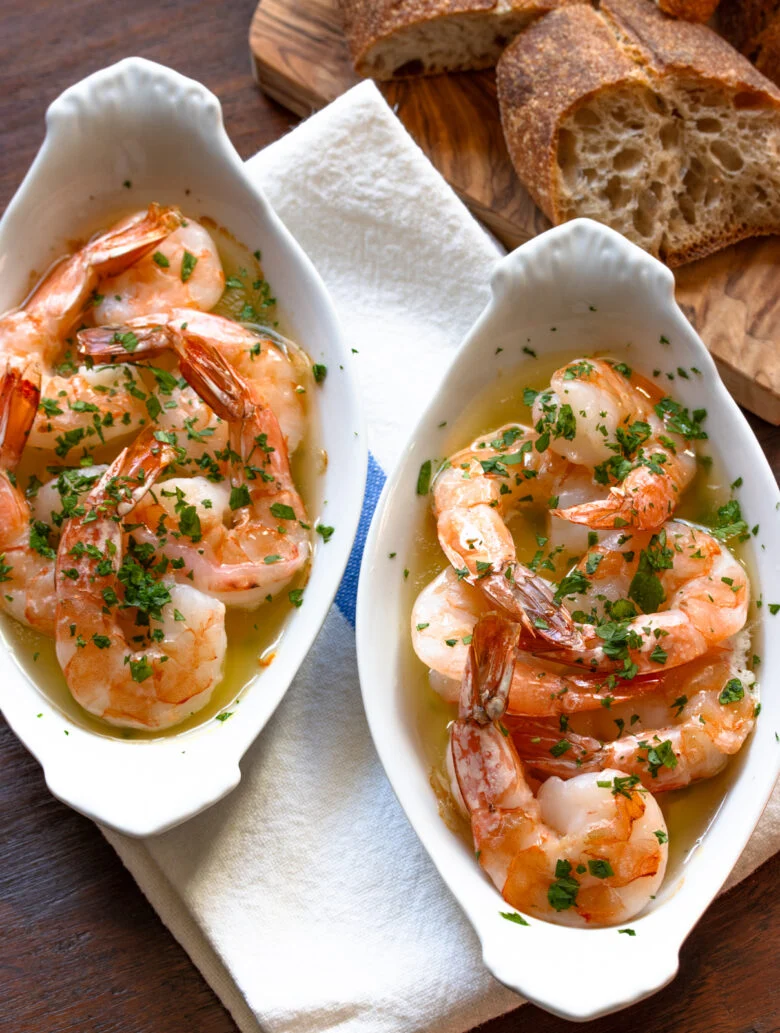 Garlic butter shrimp in a white individula gratin dishes. 