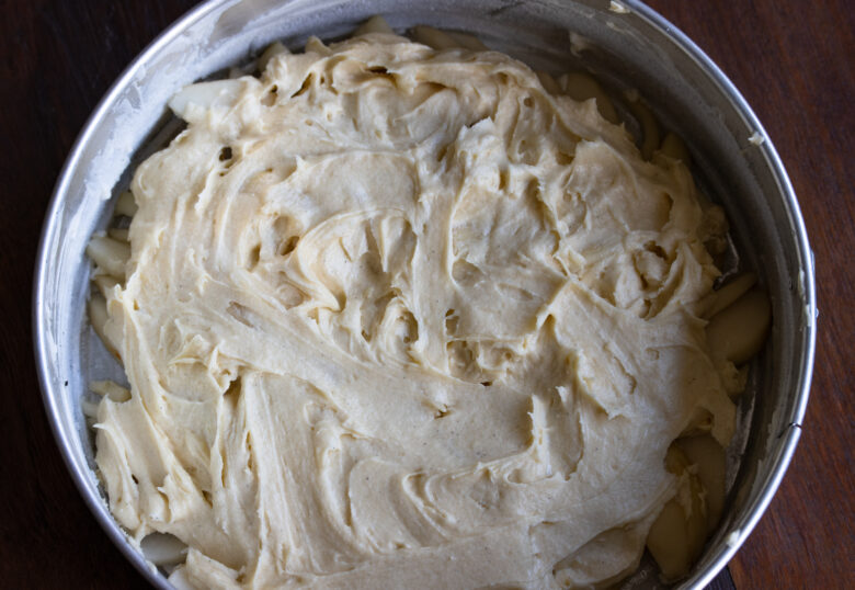 Egg batter over the pears in the springform baking dish.