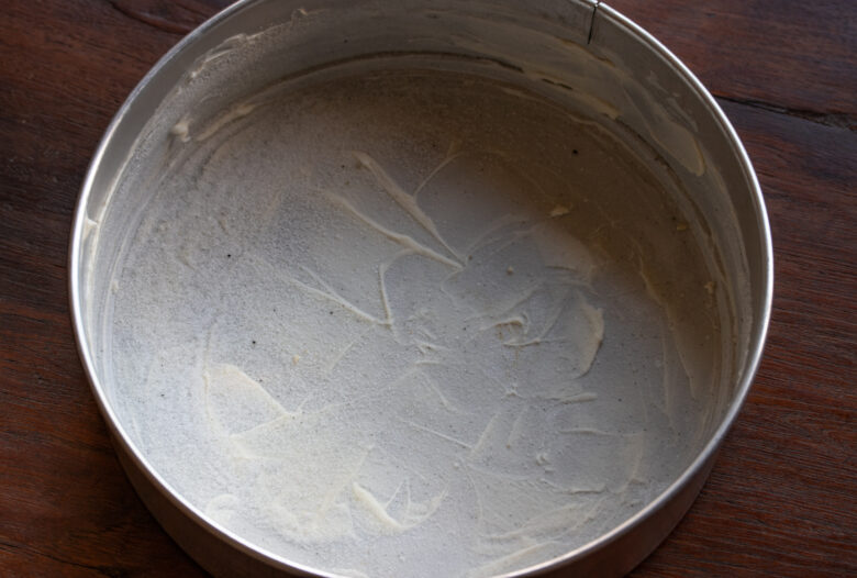 Springform baking pan fully covered with butter and sugar.