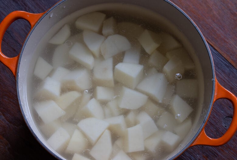 Cut potatoes placed into a pot covered with water and salt added it. 