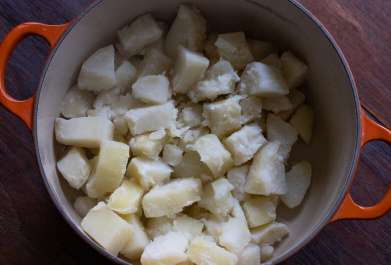 Cooked potatoes cubes back in the pan to remove all extra water.