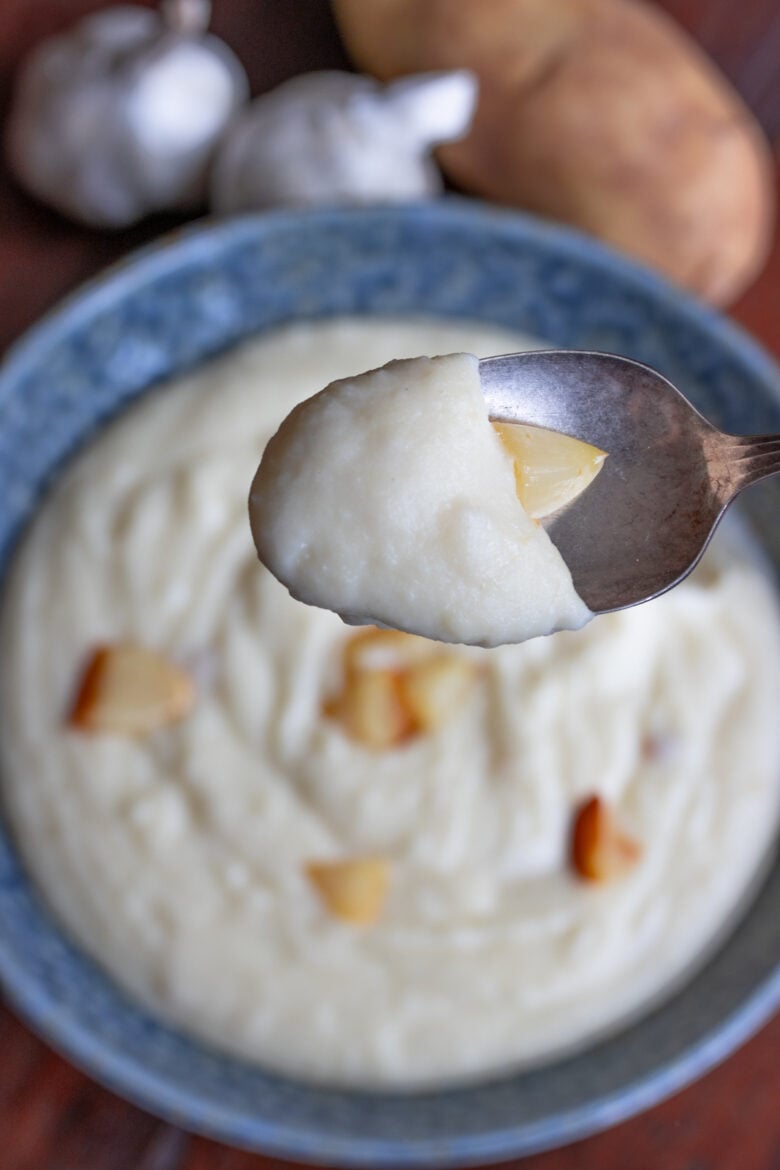 A spoonful of garlic mashed potatoes. 