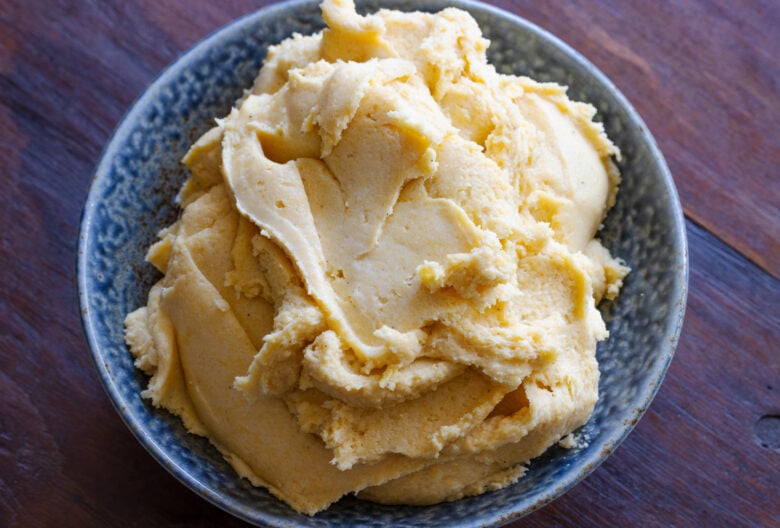 Polenta served in a blue container ready to be enjoyed.