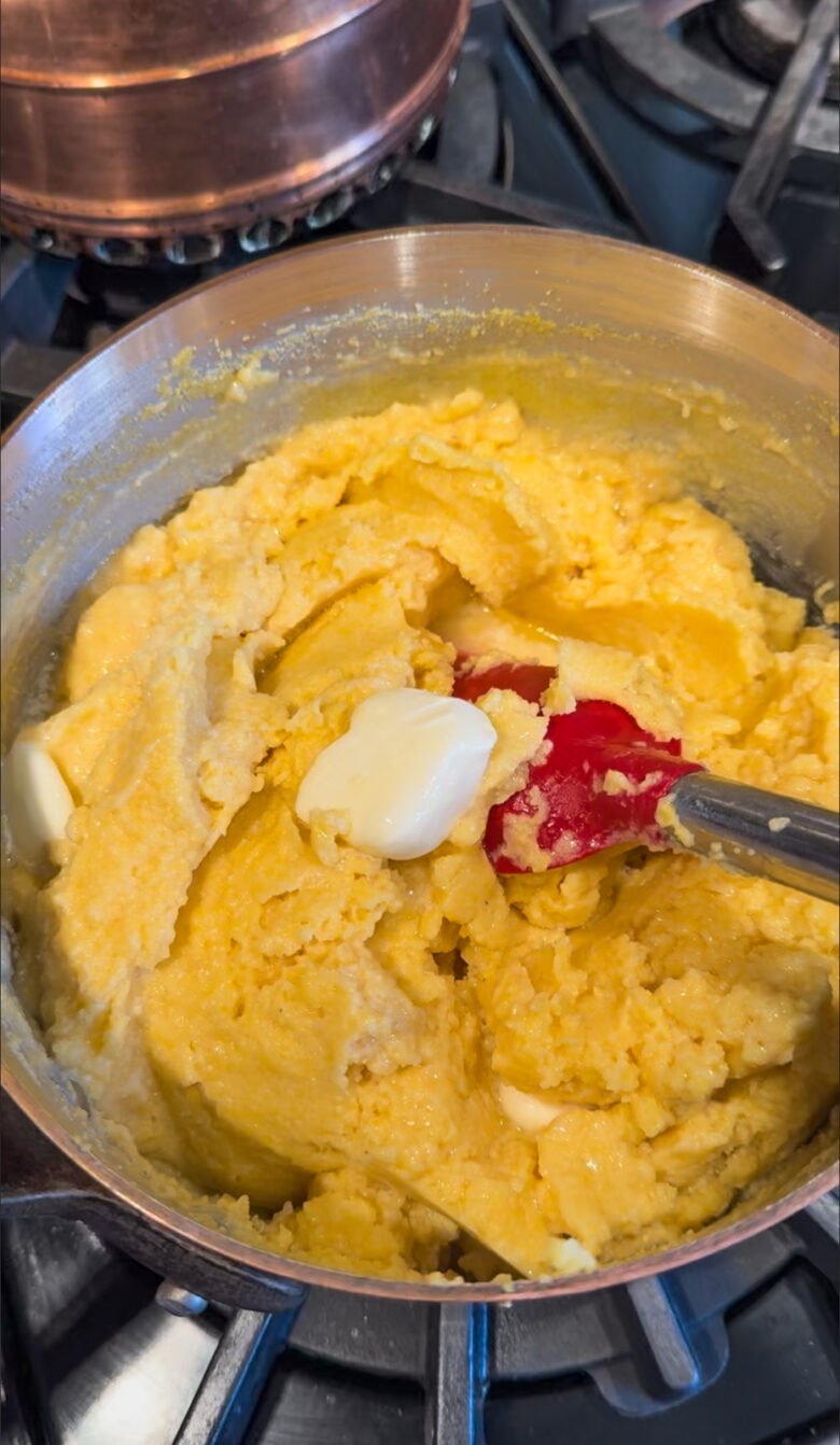 Adding butter to the polenta.