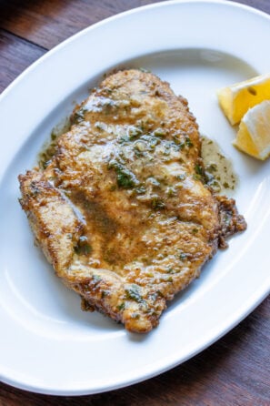 Chicken Francese served on an oval white plate.