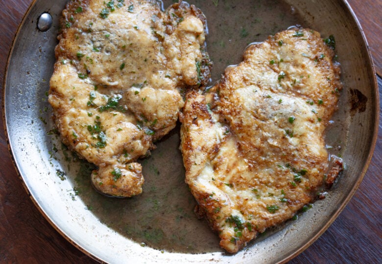 Cutlets in skillet finished and with broth and wine added to create the sauce.