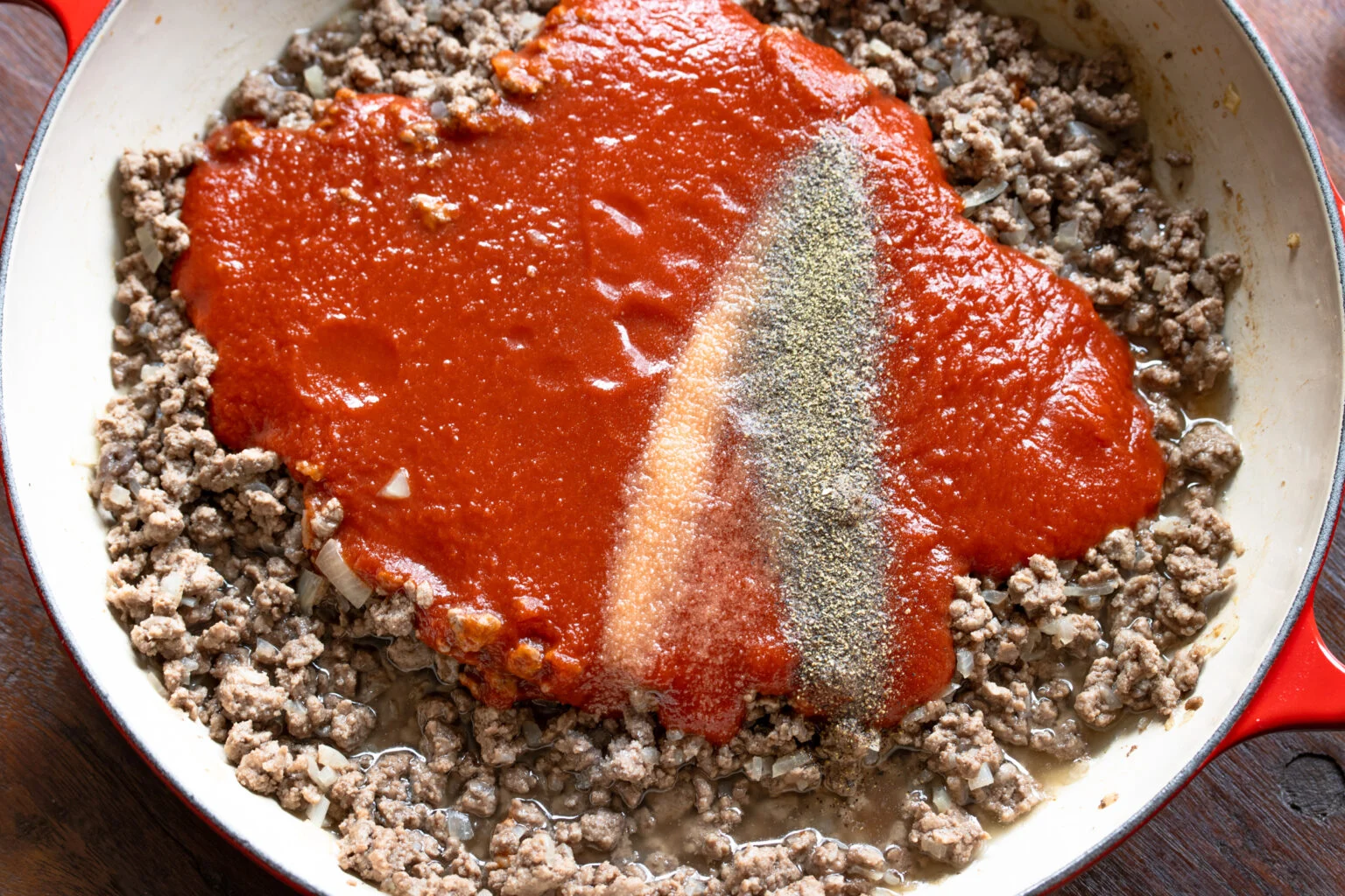 Tomato sauce added to the ground beef and seasoned with salt and pepper.