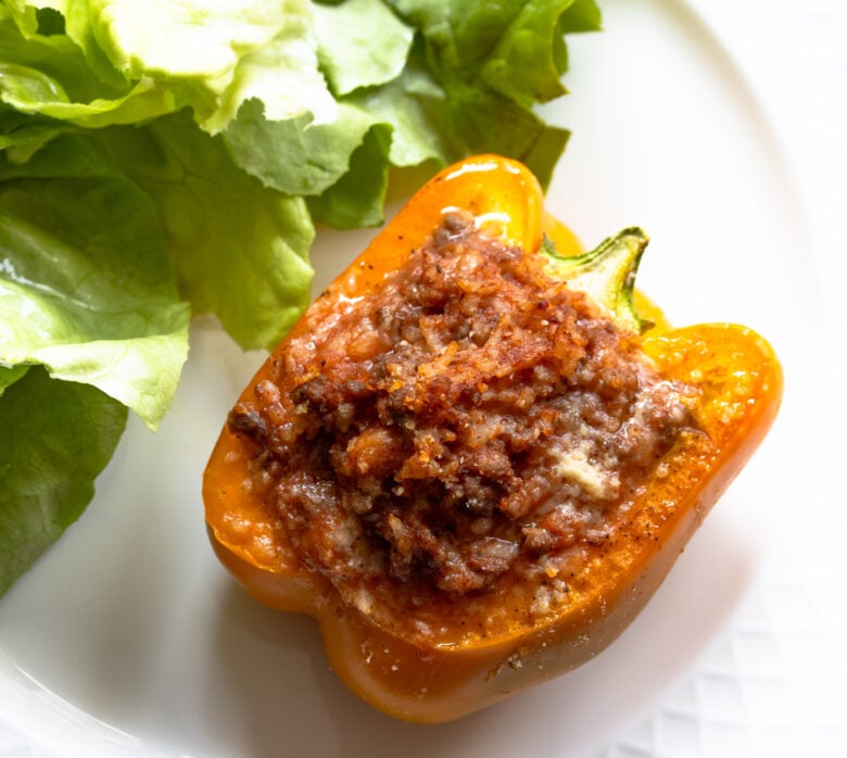 Close up of a stuffed bell pepper with ground beef and rice.