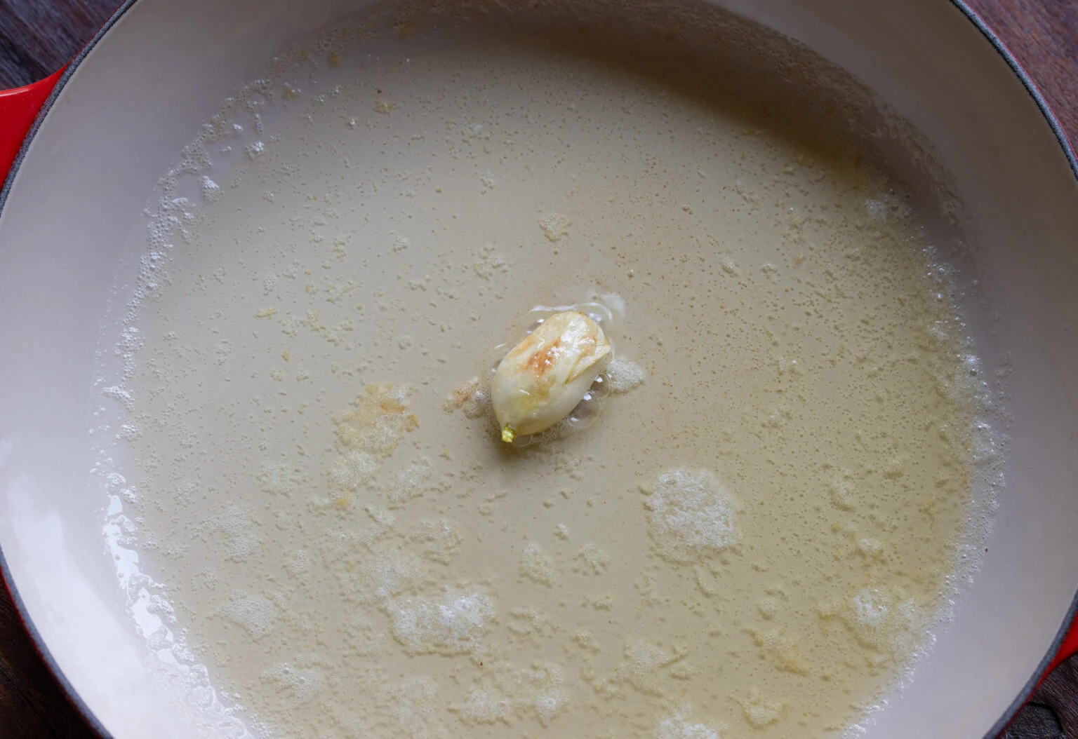Roasting the garlic with the butter and oil.