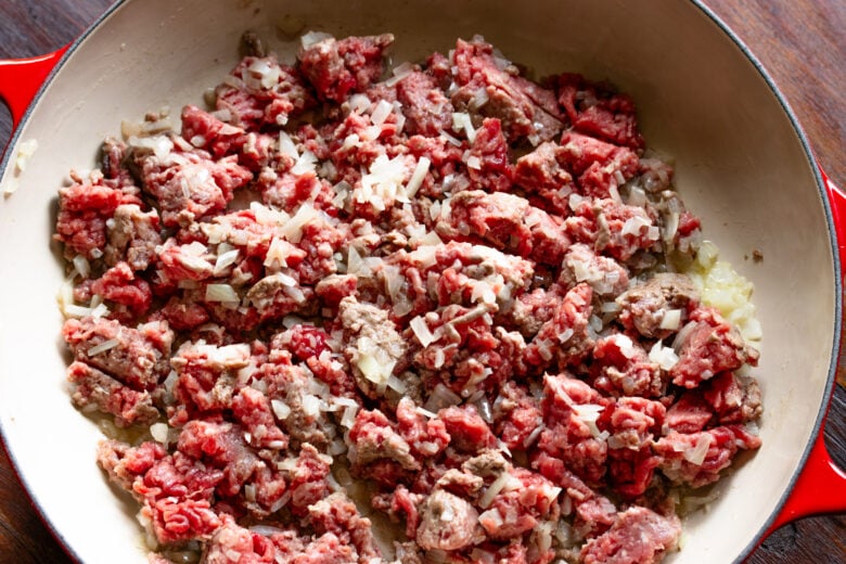 Added ground meat to the onion ans breaking doen to small pieces.