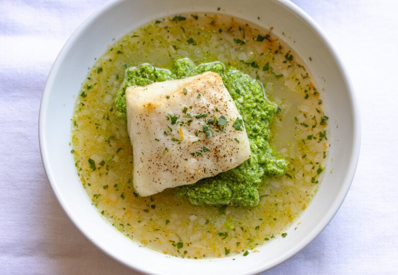 Assembled sea bass with pea puree in the lemon soup.