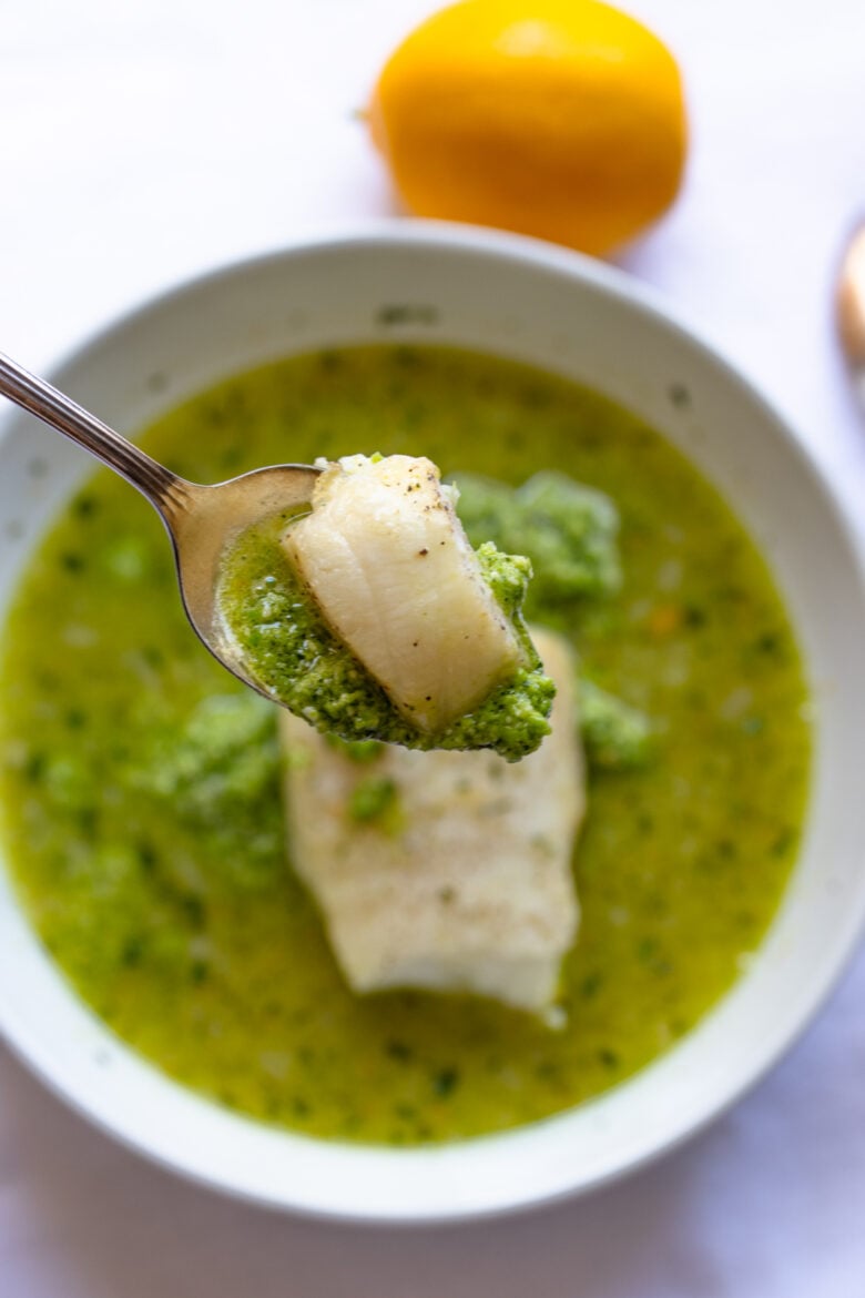 Sea bass with pea puree on a spoon, close up.
