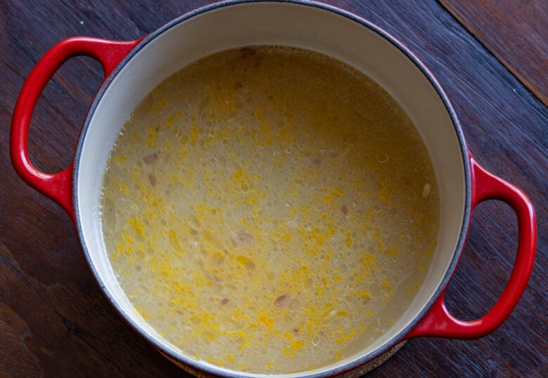 Lemon juice, chicken stock and white wine are added to the shallots.