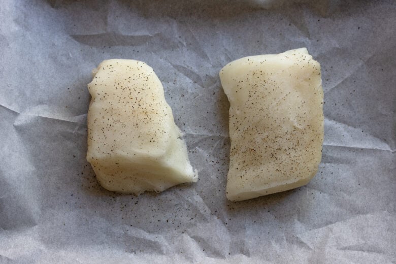 Seasoned sea bass with salt and pepper.