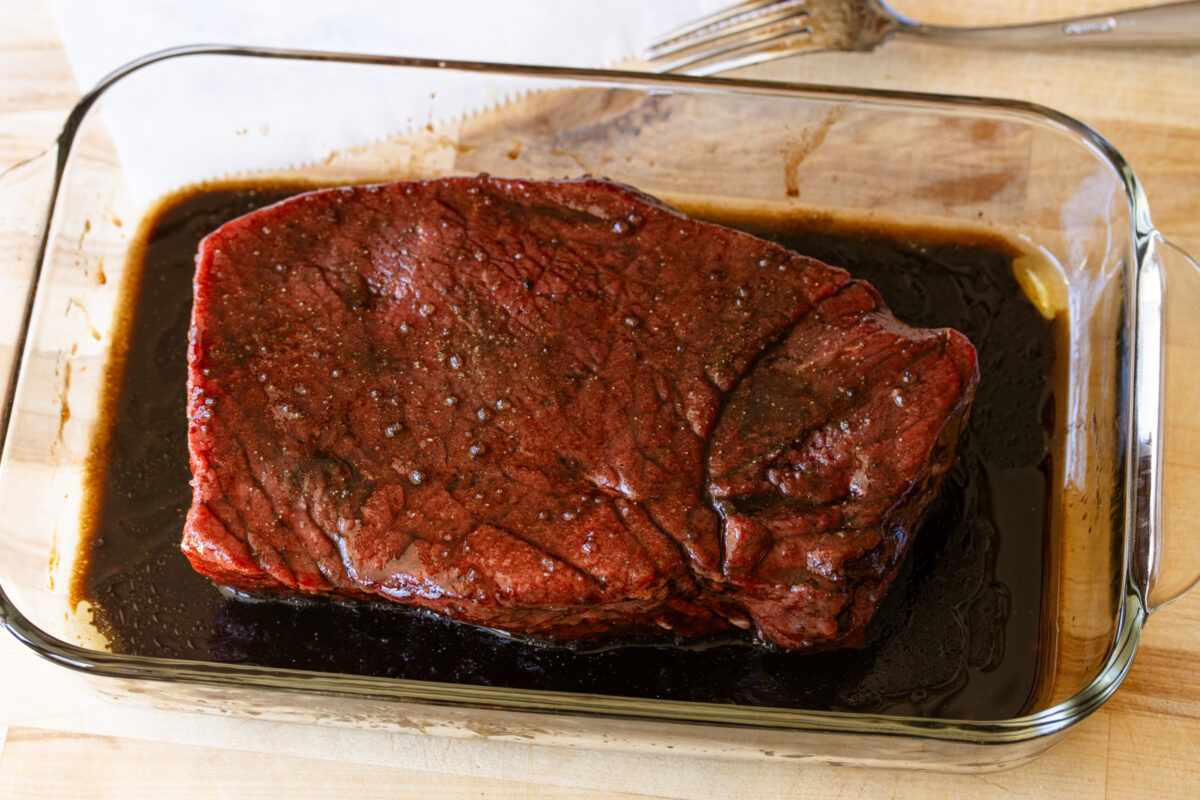 London broil marinating overnight in a glass dish.