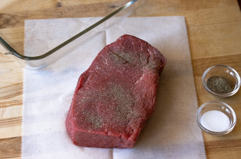 Generously seasoned meat with salt and pepper.