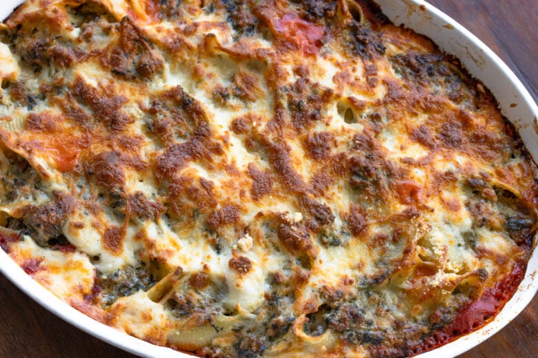 Stuffed pasta shells out of the oven with a crispy top.