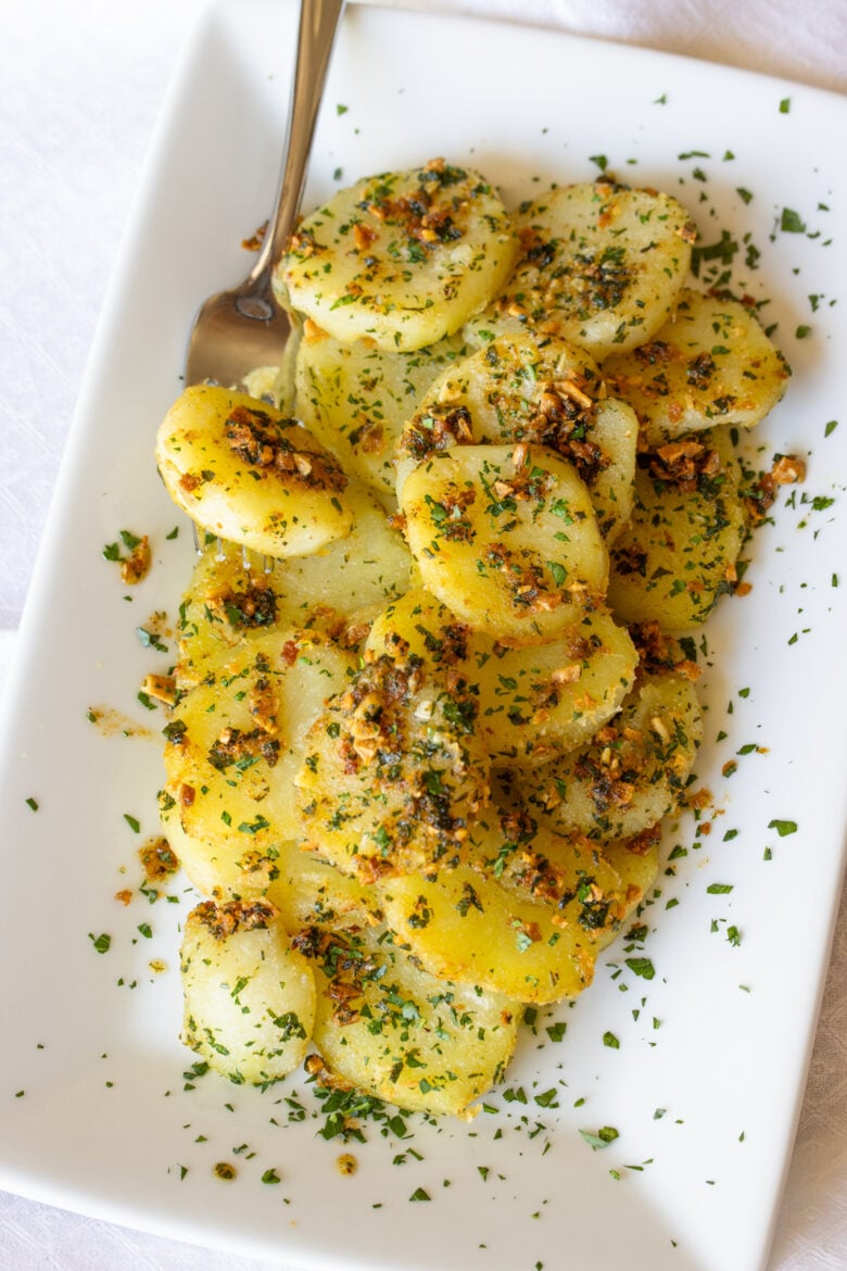 Butter garlic potatoes served in a rectangular serving plate. 