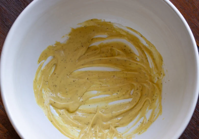 Vinaigrette created by mixing olive oil, mustard, salt and pepper.