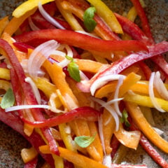 Bell pepper salad served in a brownish blue serving dish.