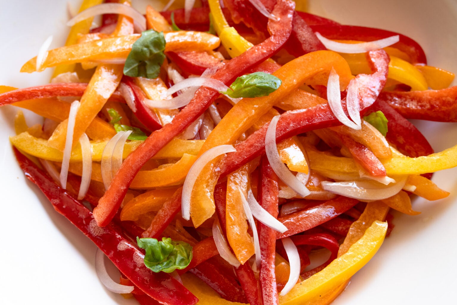 Bell pepper salad served in a white serving dish. 