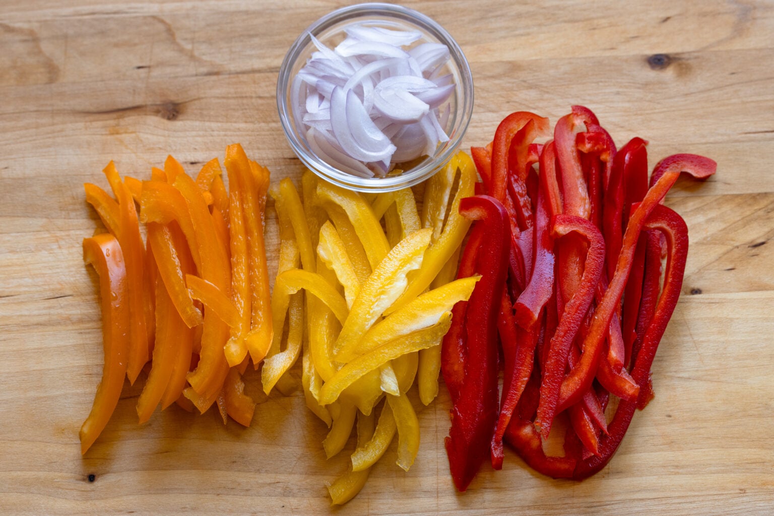 Bell peppers sliced into strips and shallots finely sliced.