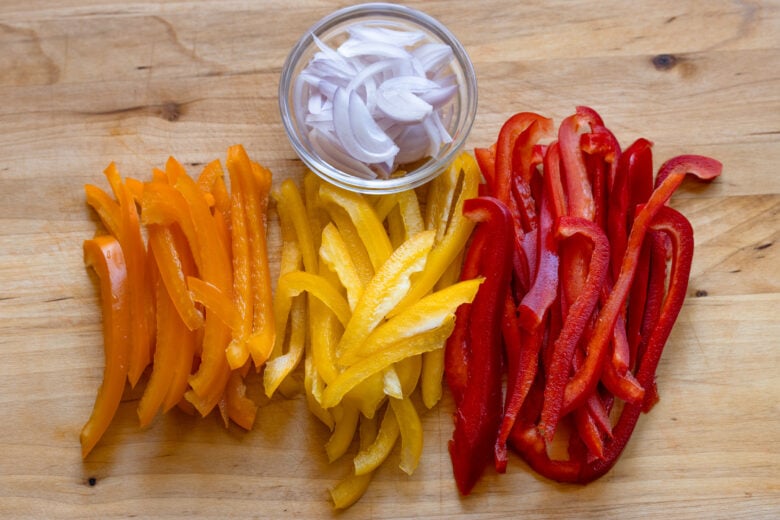 Bell peppers sliced into strips and shallots finely sliced.