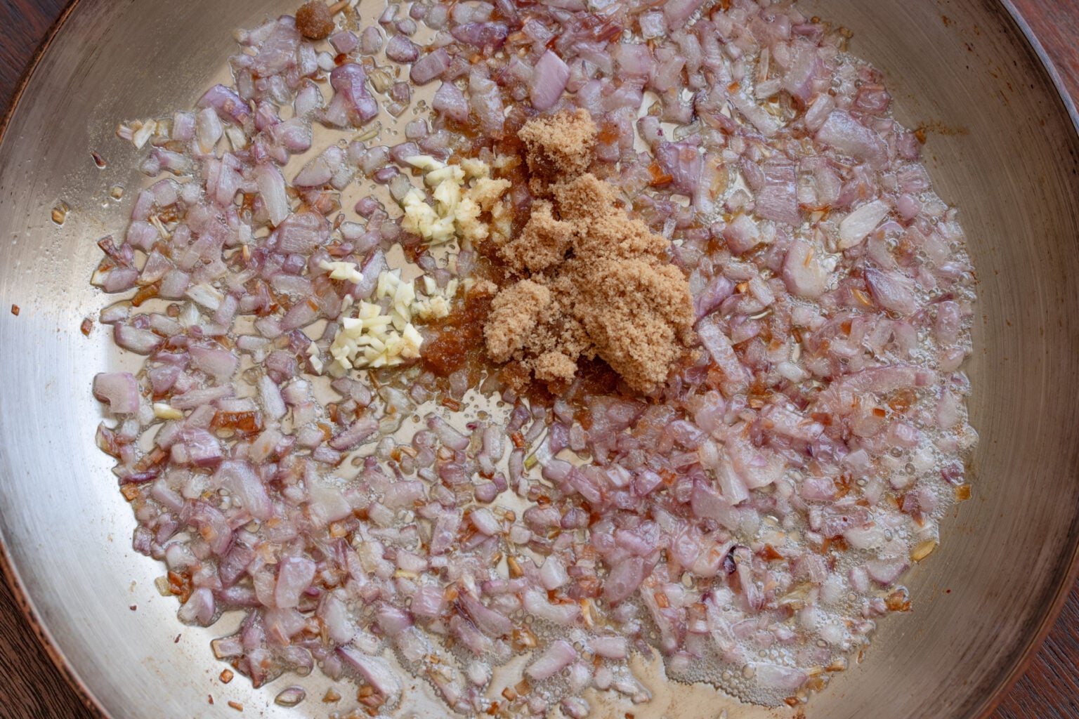 Chopped garlic and brown sugar added to the rec onion skillet.