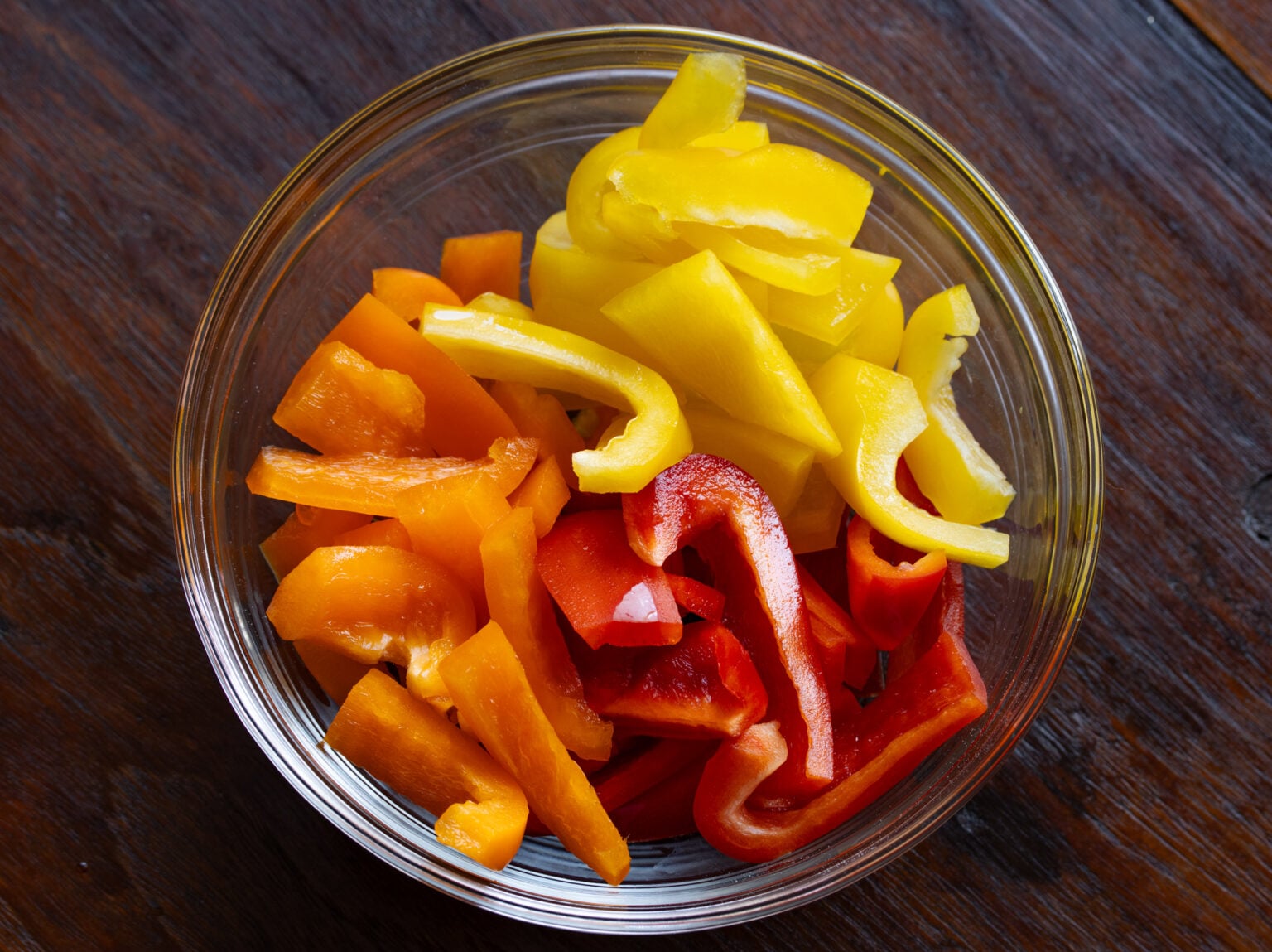 Cut into one inch chunks the bell peppers.