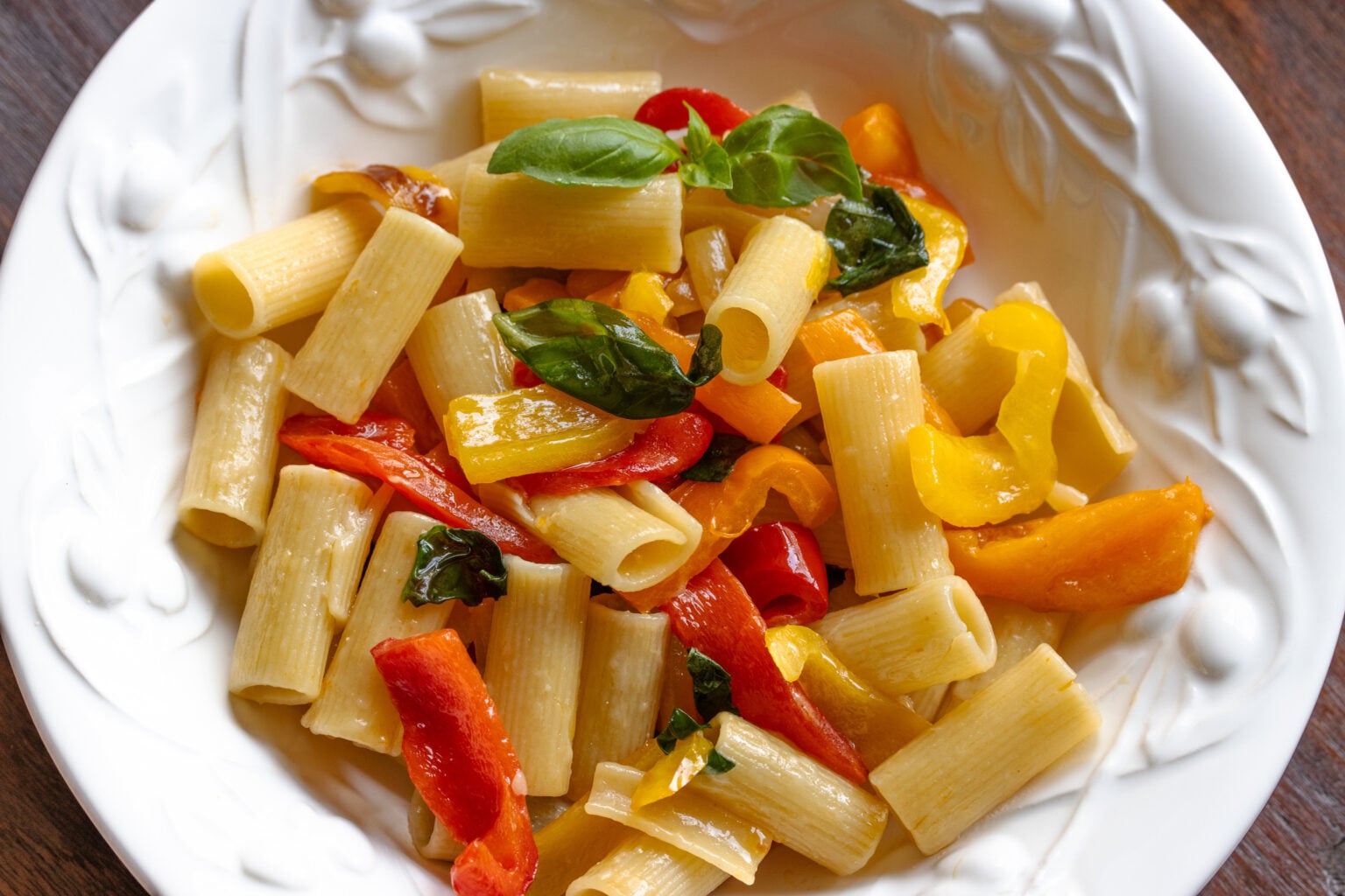 Roasted bell pepper pepper sauce with pasta served in a white dish.