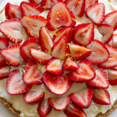 Strawberry icebox cake served on a white cake stand.