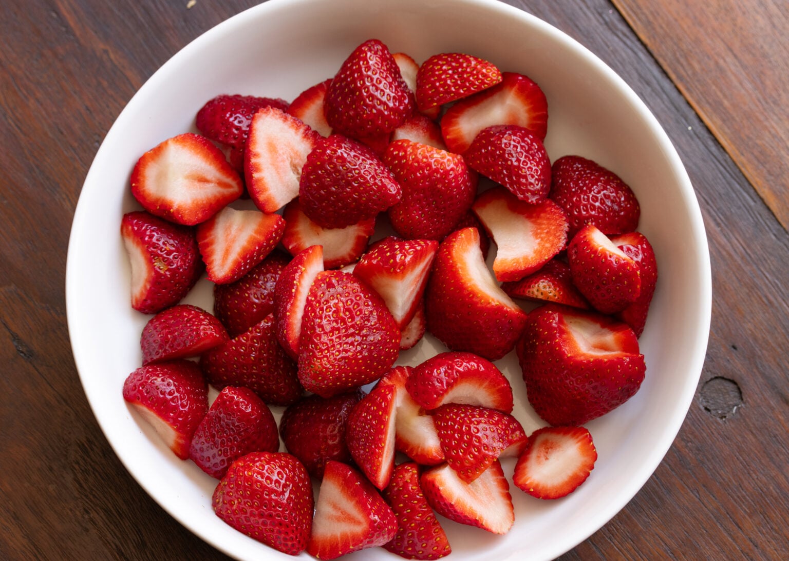 Cleaned strawberries, stem removed and sliced in half.