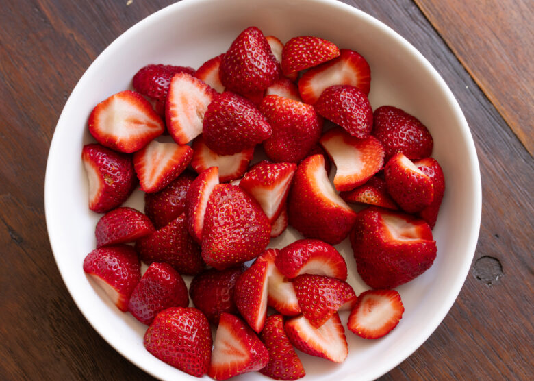 Cleaned strawberries, stem removed and sliced in half.