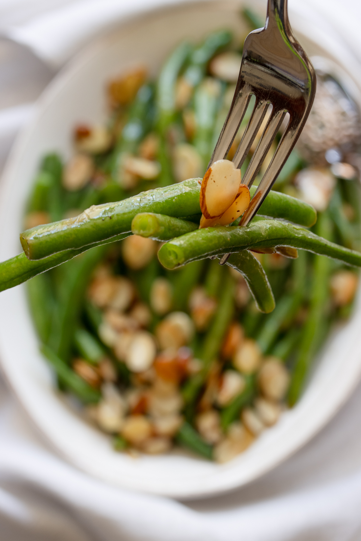 A forkful of green beans close up.
