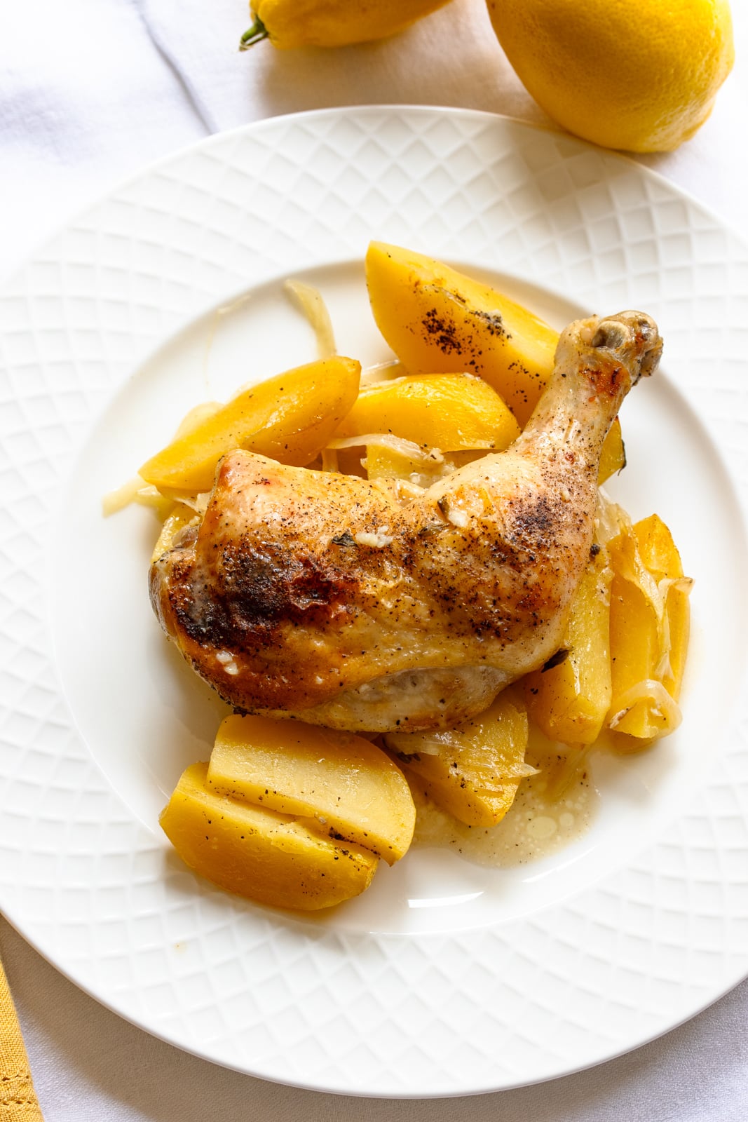 Lemon chicken ready to be enjoyed served on a white lettice plate.