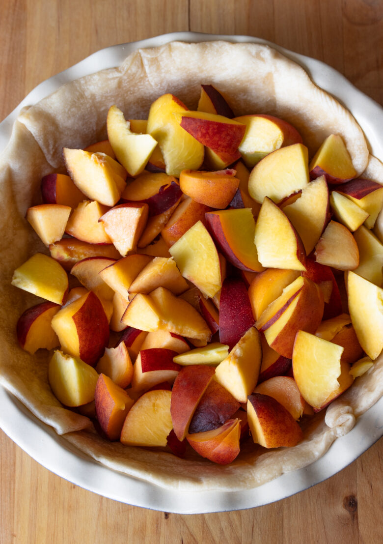 Peach chunks placed over the pie shell.