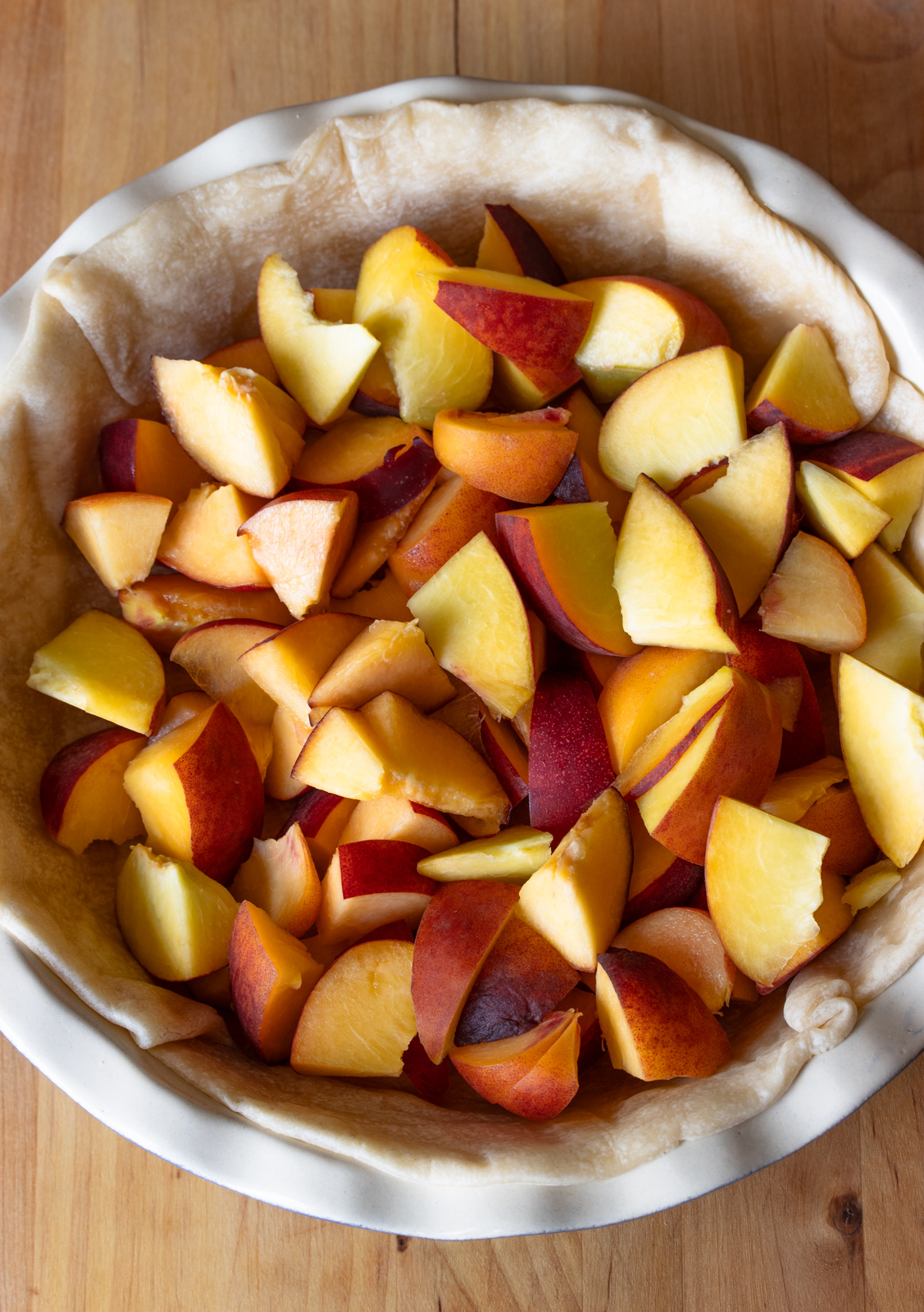 Peach chunks placed over the pie shell.