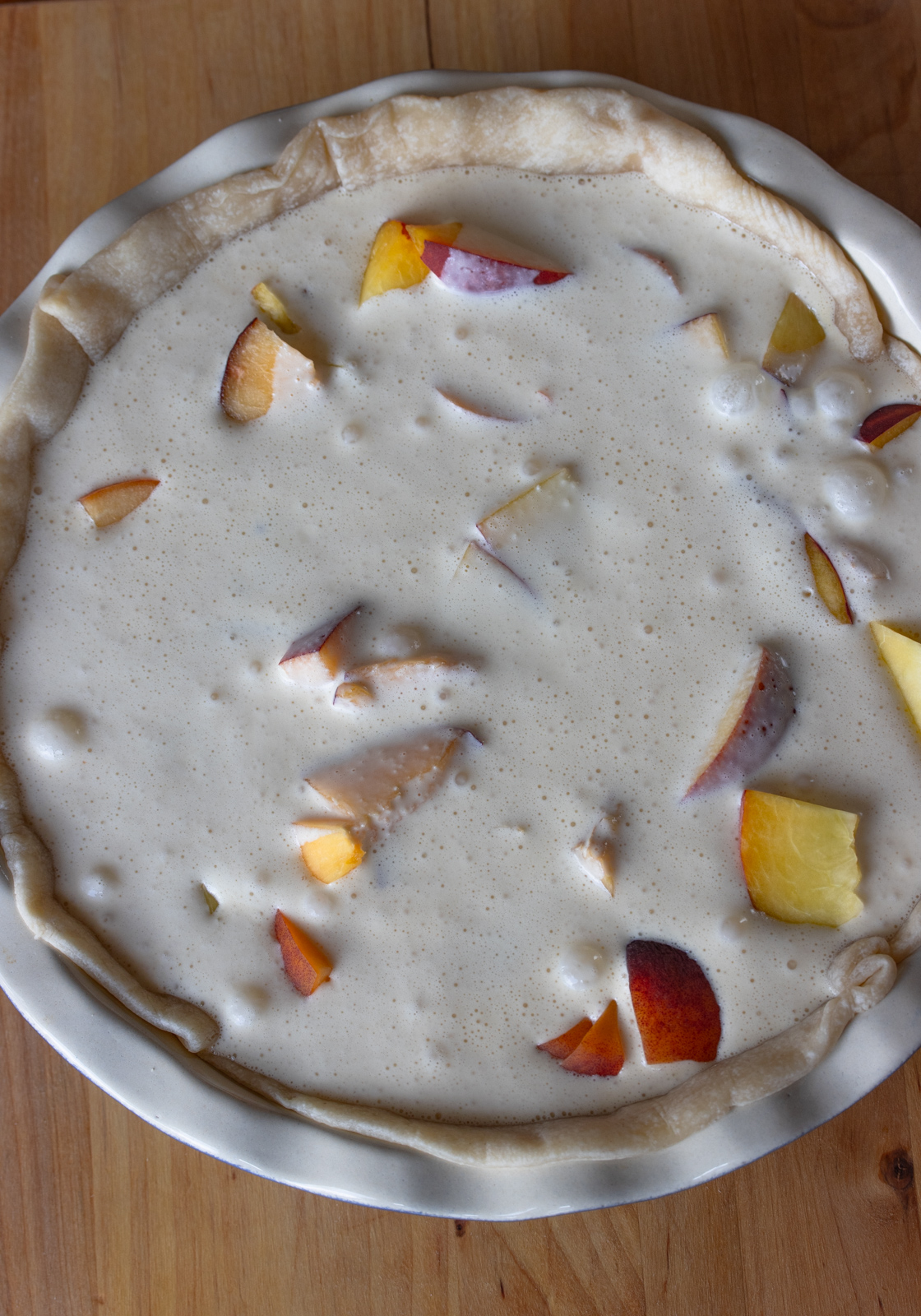 Egg cream mixture poured over the peaches.