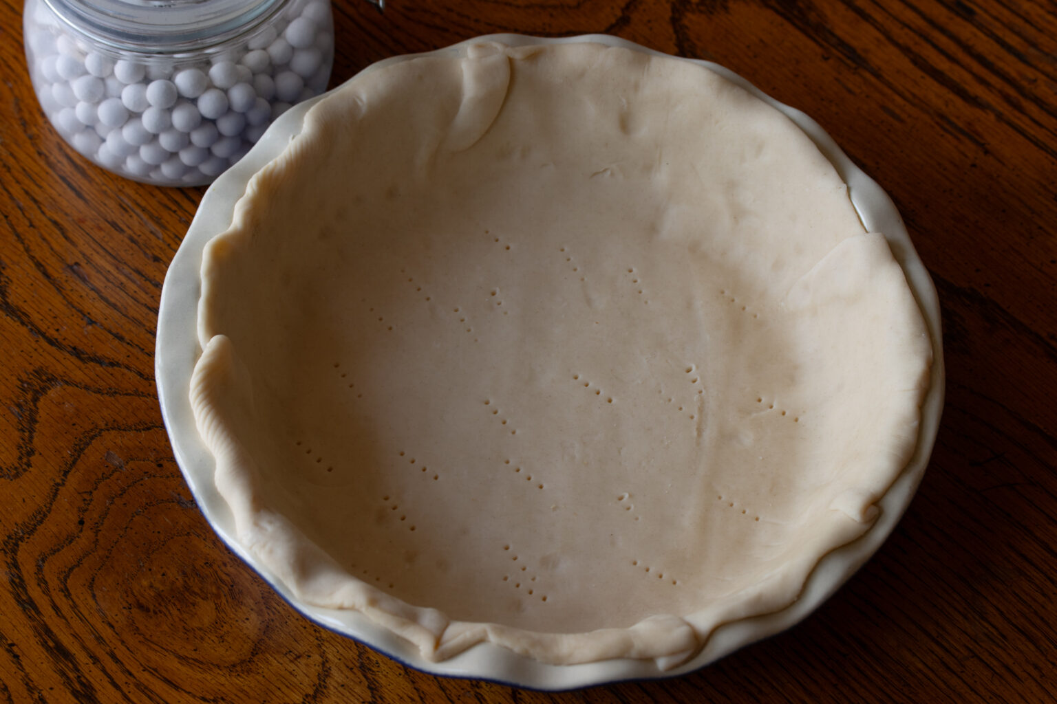 Pastry dough poked with a fork to create small holes.